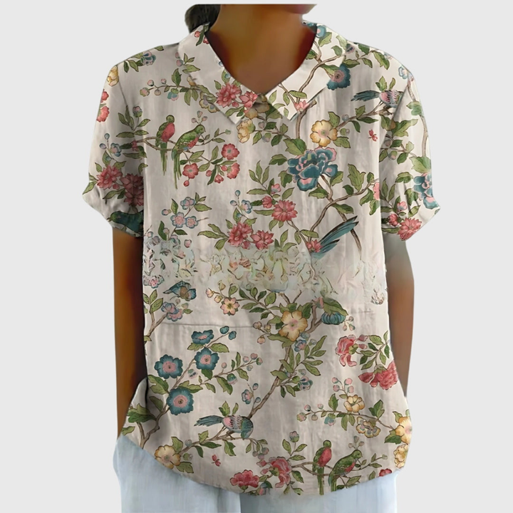 Back view of a women's patterned collared blouse. Relaxed fit, perfect for versatile summer fashion.