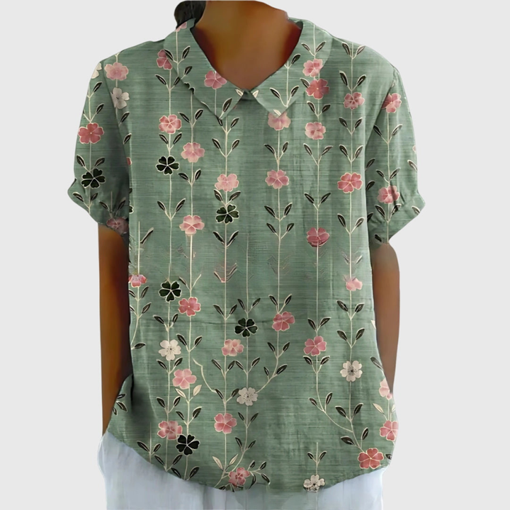 Collared floral blouse for women paired with trousers. Stylish and versatile office wear.