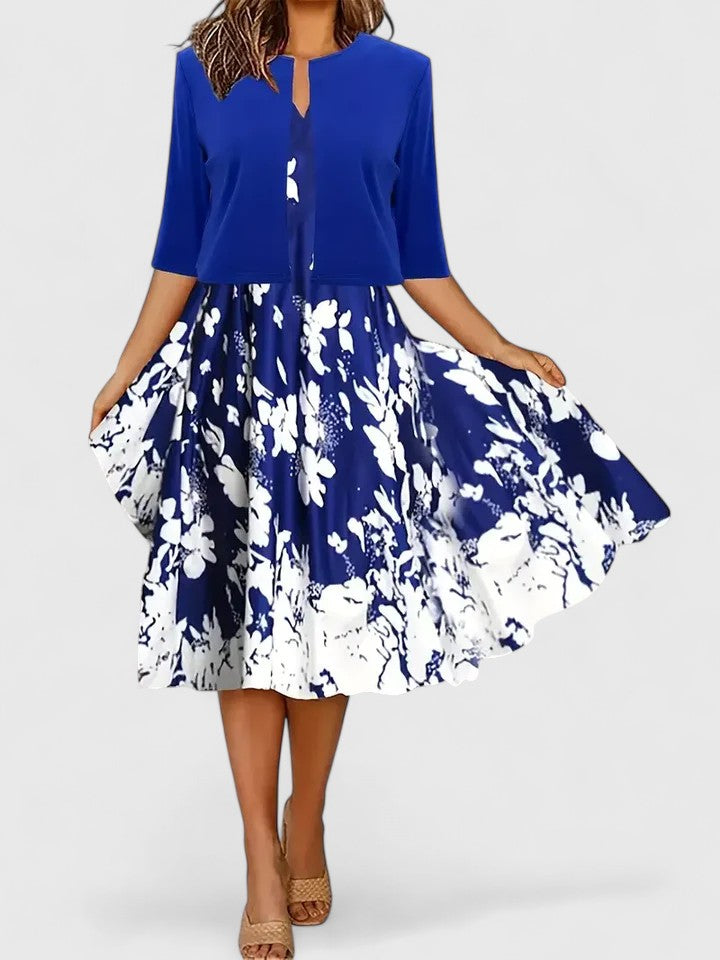 Stylish women's floral print colorblock midi dress. Features notch neck, 3/4 sleeves, and flowing A-line cut.