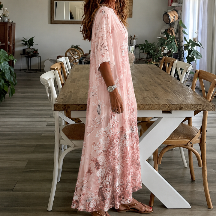 Elegant women's maxi dress featuring a vibrant floral print, half sleeves, and split neck for casual wear.