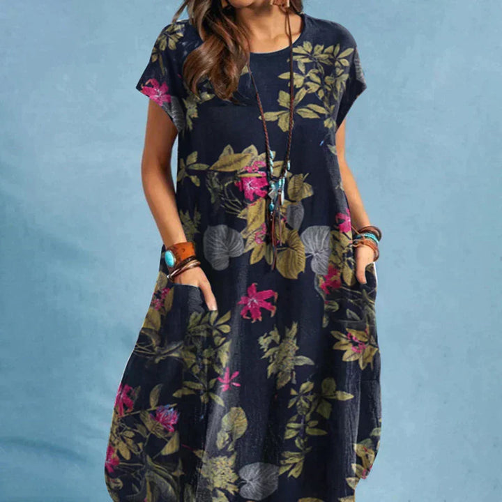 Women's floral print midi dress with side pockets, short sleeves, and a round neck, perfect for summer casual wear.
