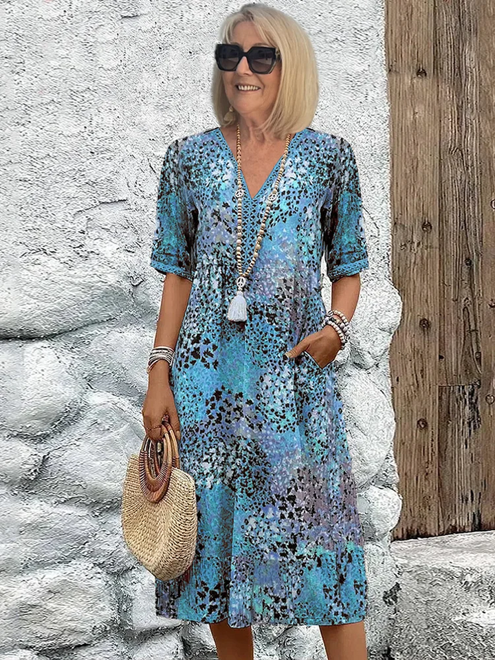 Casual women's A-line midi dress featuring a stylish V-neck and beautiful floral pattern. Comfortable summer wear.