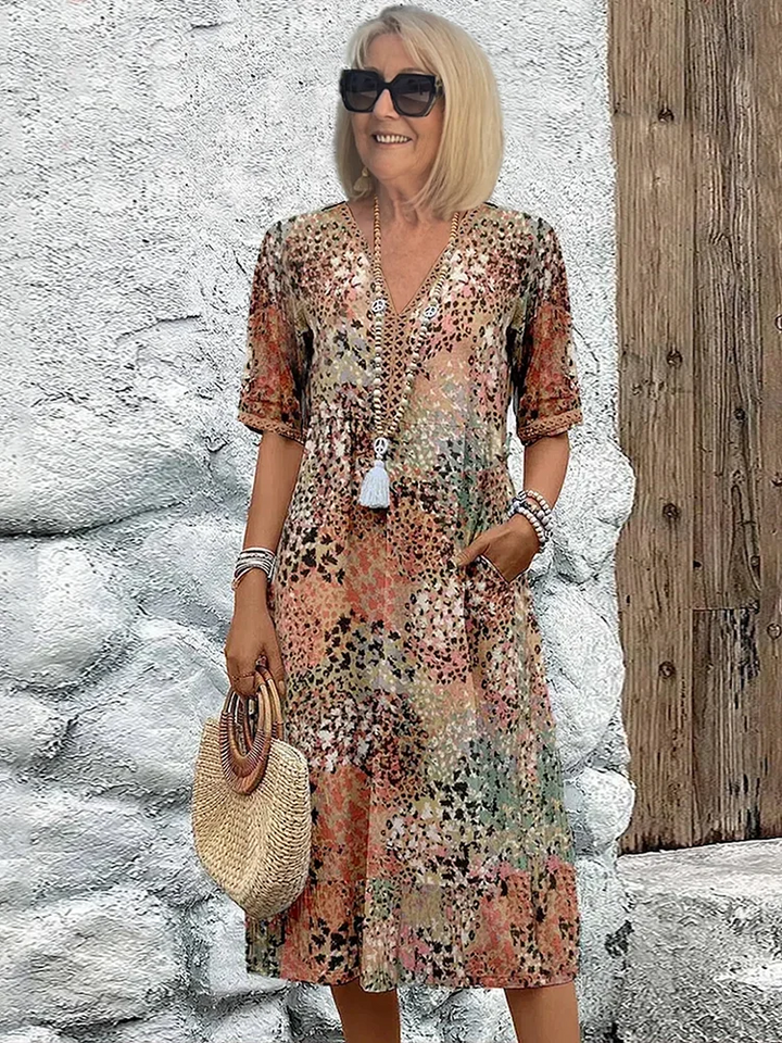 Stylish women's floral midi dress with an elegant V-neck, designed for comfortable, casual summer wear.