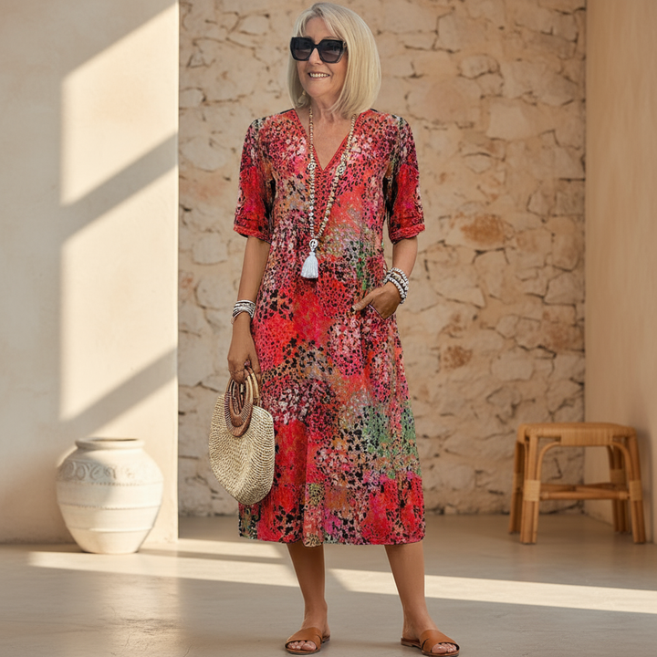 Vibrant floral print women's midi dress with a V-neck and A-line cut. Perfect for a chic and comfortable summer.