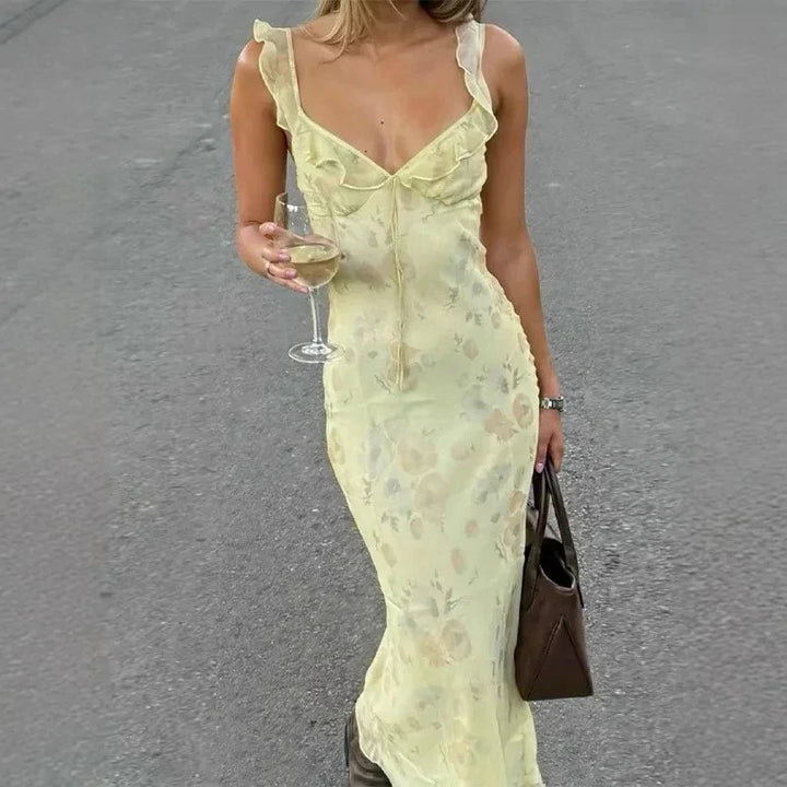 Elegant women's sleeveless floral beach dress for summer. Comfortable vacation apparel for sunny days.