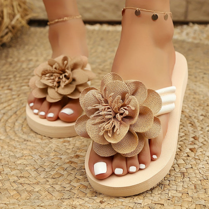 Floral sandals for women, yellow with cheerful flower design, on sand, ideal for summer, comfort