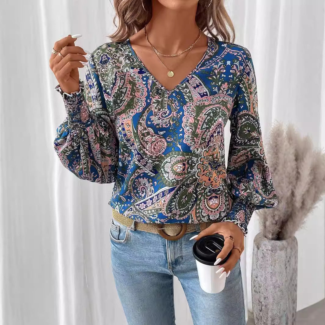 Women's floral V-neck blouse with elegant lantern sleeves. Perfect for spring & summer fashion.