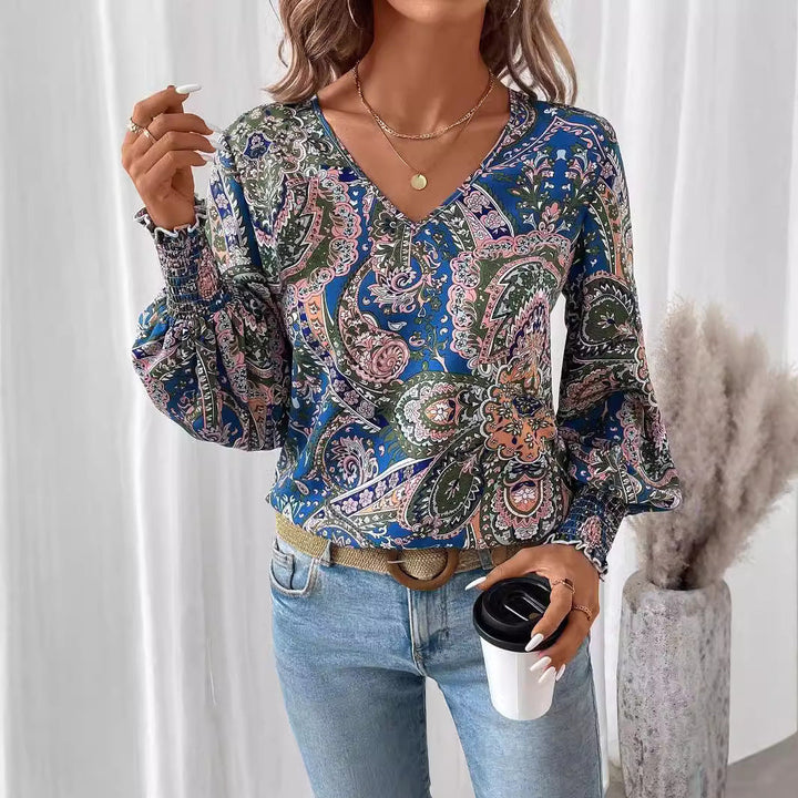 Women's floral V-neck blouse with elegant lantern sleeves. Perfect for spring & summer fashion.