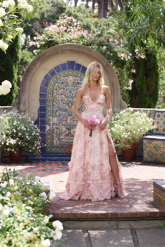 Women's long floral wedding guest dress with a flattering V-neck and delicate ruffle details.