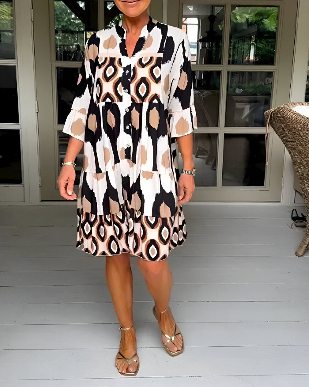 Women's flowing bohemian tiered dress with vibrant geometric print, ruffle sleeves, and mandarin collar, perfect for summer.