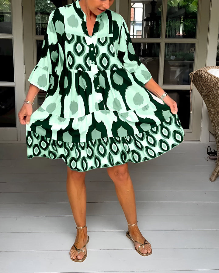 Elegant long bohemian tiered dress for women with a unique geometric print, ruffle sleeves, and mandarin collar.