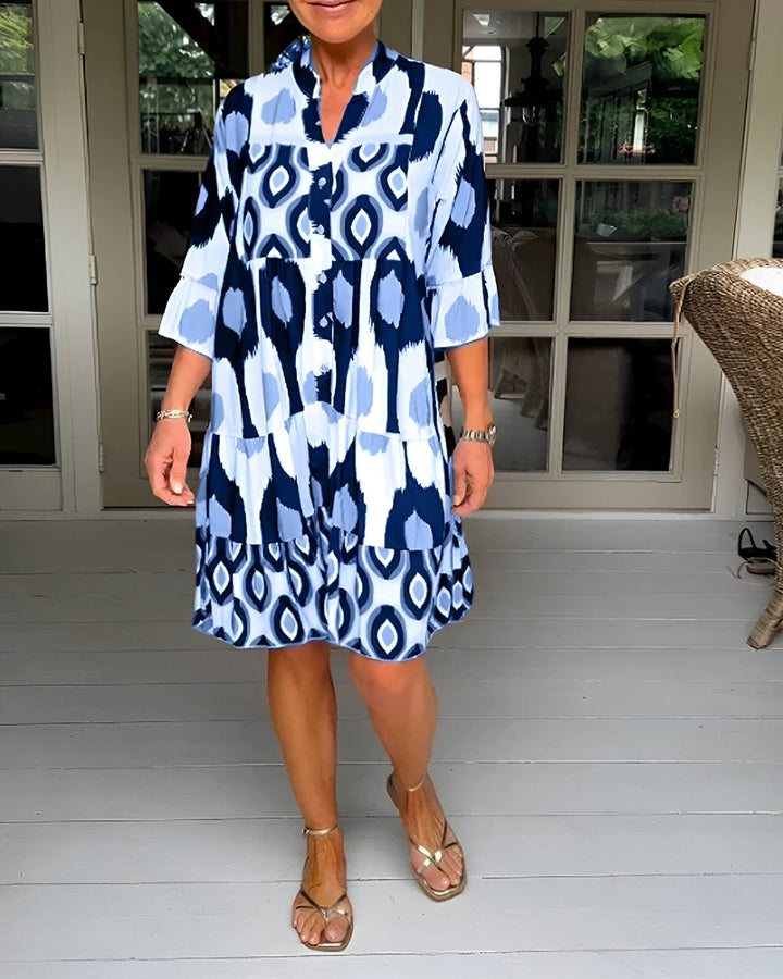 Flowing women's bohemian midi dress with a stylish geometric print and tiered design, suitable for casual occasions.