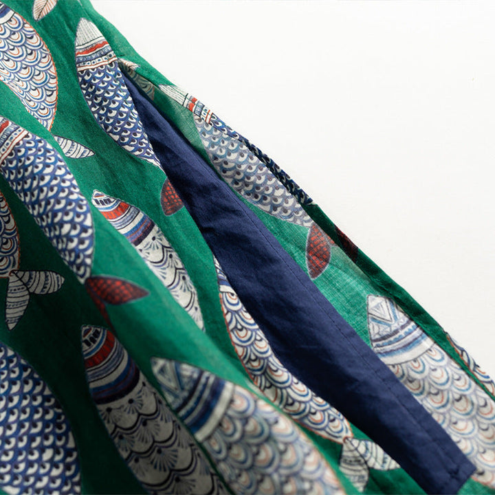 Comfortable flowing women's dress with a playful fish print and sleeveless design, ideal for warm weather.