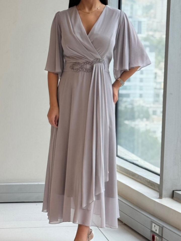 Women's flowing V-neck maxi dress with adjustable straps, perfect for summer, resort, or casual wear.