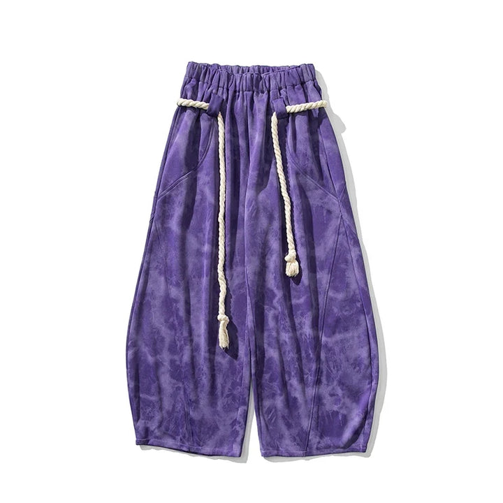 Textured women's flowing wide-leg pants, cinched with a fashionable rope belt, enhancing a stylish outfit.