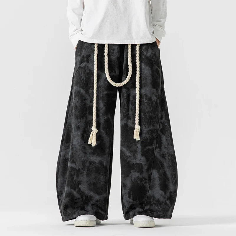 Relaxed fit women's wide-leg pants with a decorative rope belt, showcasing a flowing and stylish design.