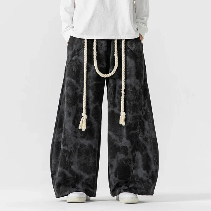 Relaxed fit women's wide-leg pants with a decorative rope belt, showcasing a flowing and stylish design.
