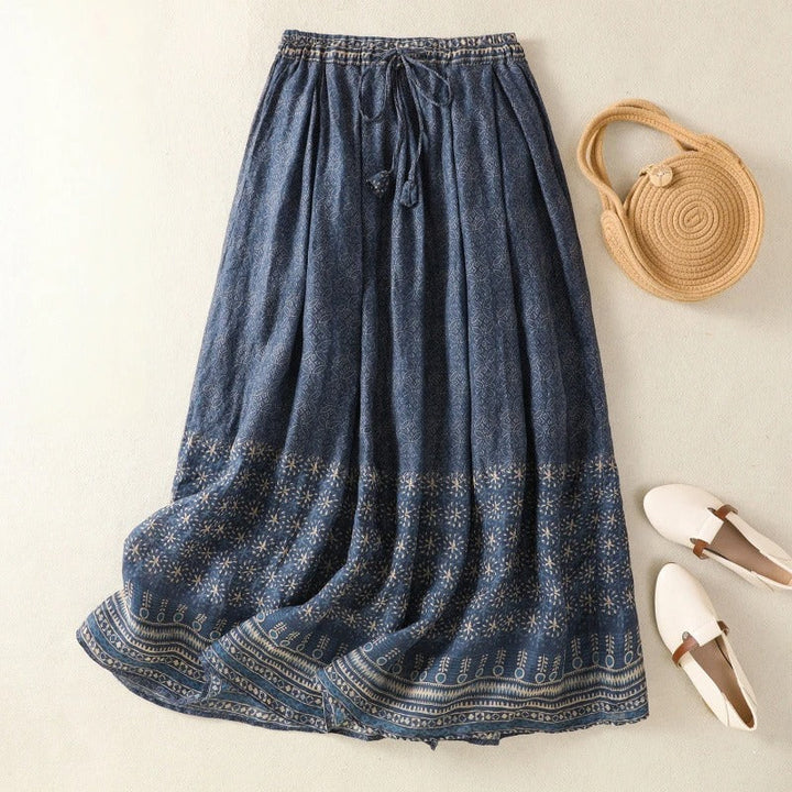 Women's flowy A-line skirt with a vibrant print and comfortable drawstring waist, perfect for summer casual wear.