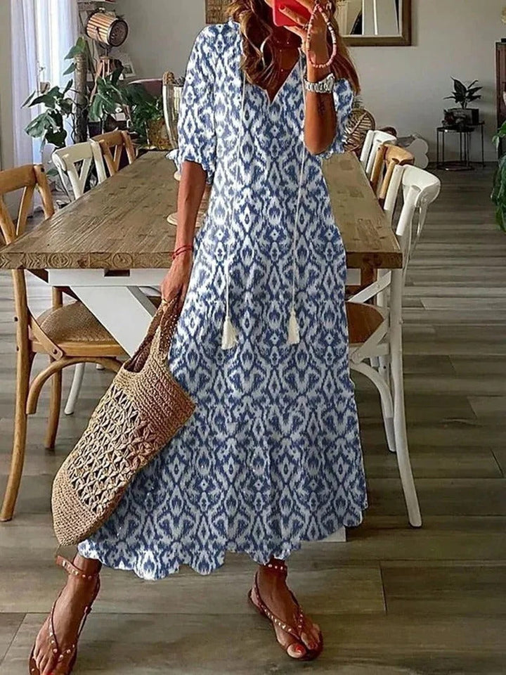 Women's flowy boho maxi dress with V-neck and three-quarter sleeves, perfect for summer casual wear.