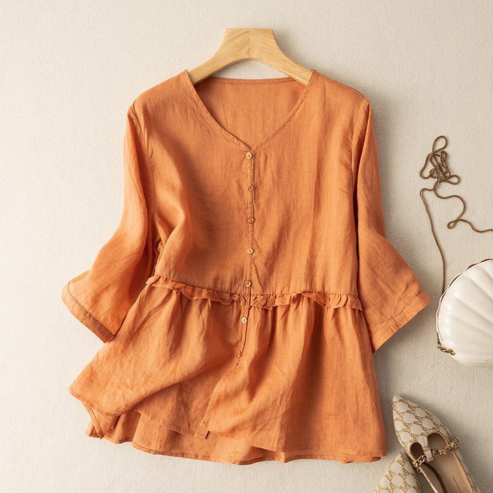 Stylish women's spring/summer blouse; a comfortable, flowy button-down top with three-quarter sleeves and gathered details.