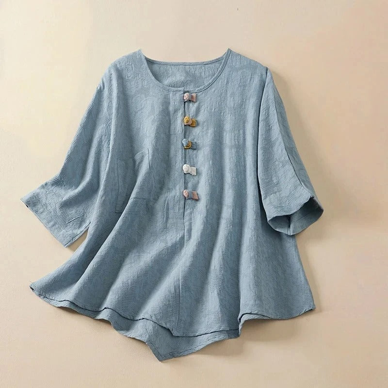 Women's flowy button-down blouse with unique knotted details, perfect for a chic and elegant look. Long sleeve top.