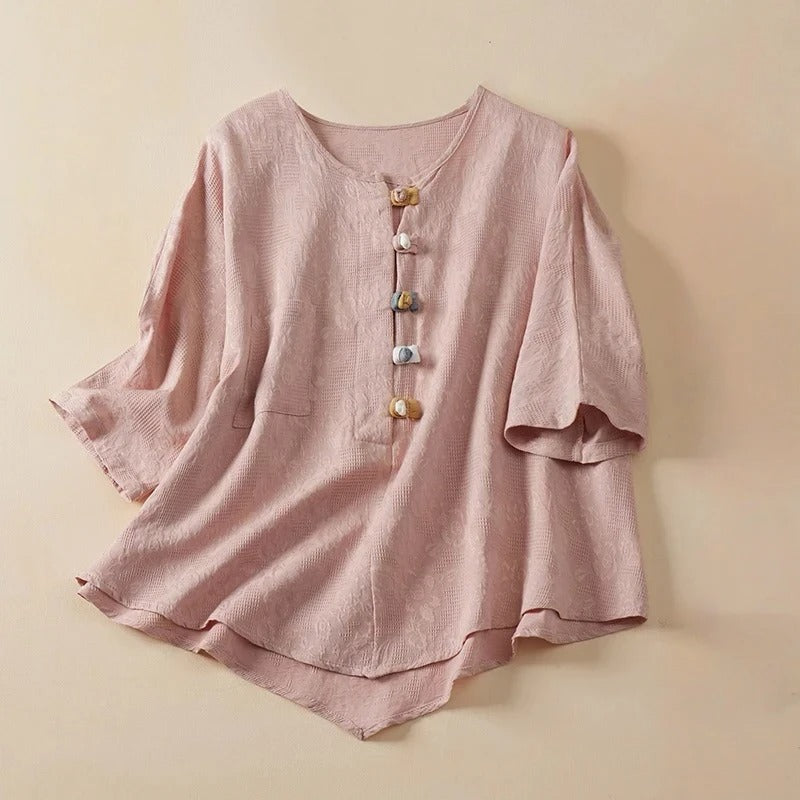 Elegant women's long-sleeve button-down blouse featuring distinctive knotted buttons. Casual yet chic flowy top.