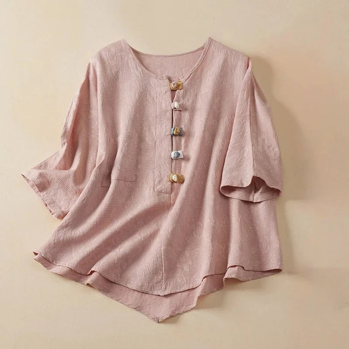 Elegant women's long-sleeve button-down blouse featuring distinctive knotted buttons. Casual yet chic flowy top.