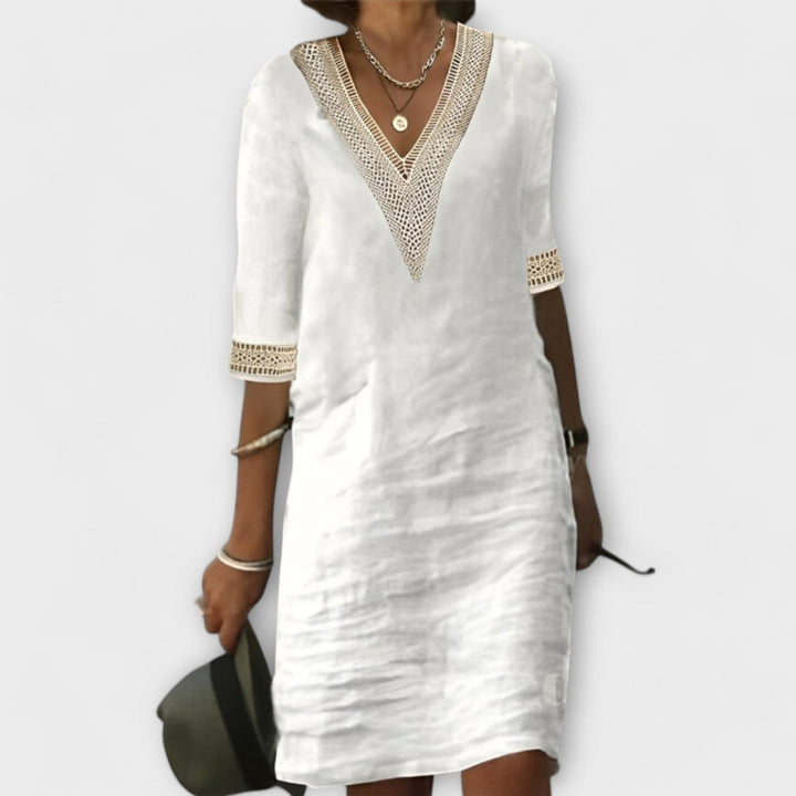 Women's flowy crochet midi dress with intricate openwork design, perfect for a bohemian summer or beach vacation.