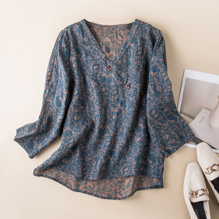 Women's flowy crossover blouse with delicate print, ideal for casual spring & summer style.