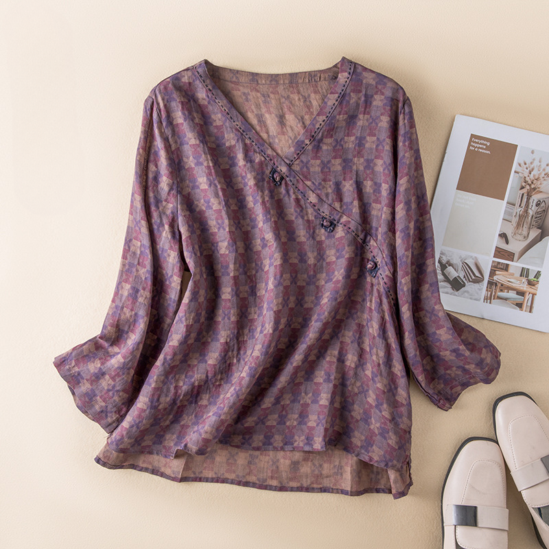 Lightweight women's flowy crossover blouse with delicate bohemian print, perfect for summer comfort.