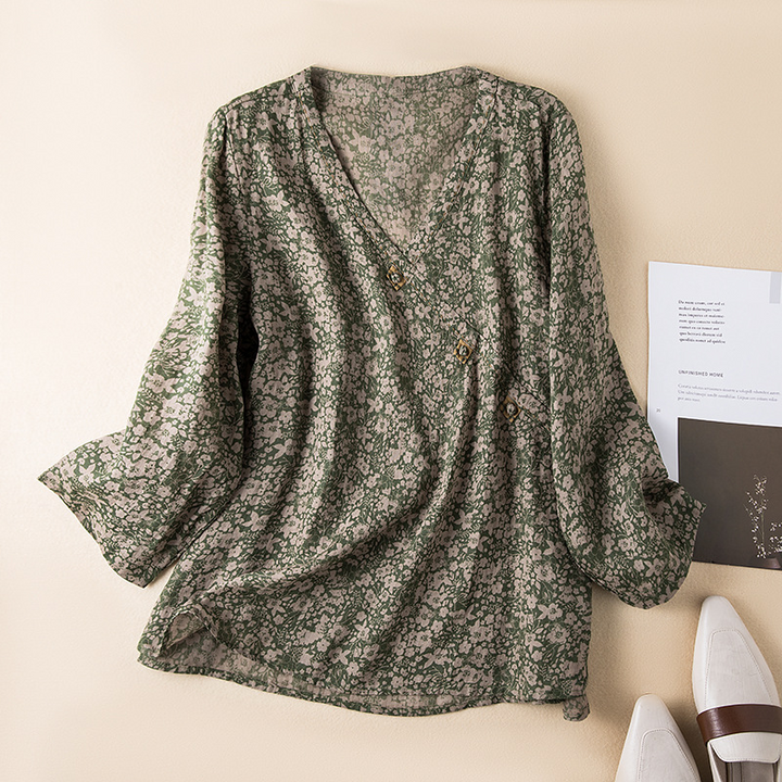 Stylish women's flowy crossover blouse with a delicate all-over print, great for airy summer wear.