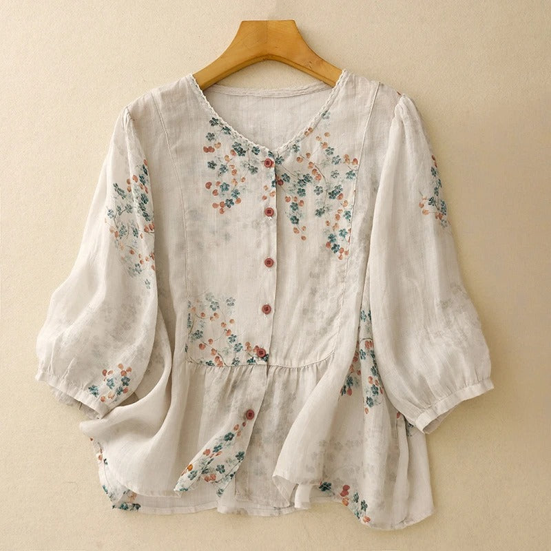 Women's flowy floral blouse with long sleeves, perfect for a casual summer or elegant bohemian look.