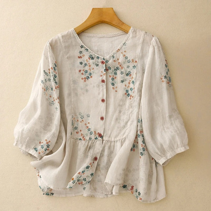 Women's flowy floral blouse with long sleeves, perfect for a casual summer or elegant bohemian look.