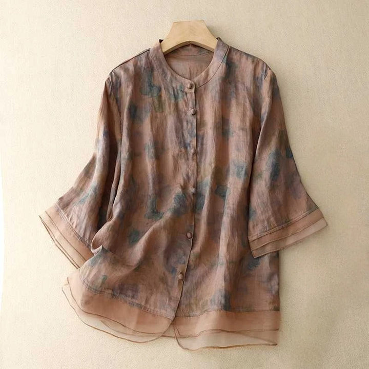 Chic women's floral print blouse. Features a flowy design, long sleeves, and a stylish mandarin collar for an elegant look.