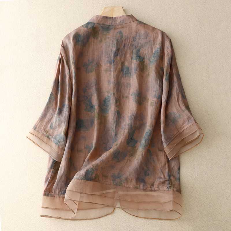 Fashionable women's floral print blouse. Comfortable flowy design with long sleeves, a chic mandarin collar, and vibrant print.