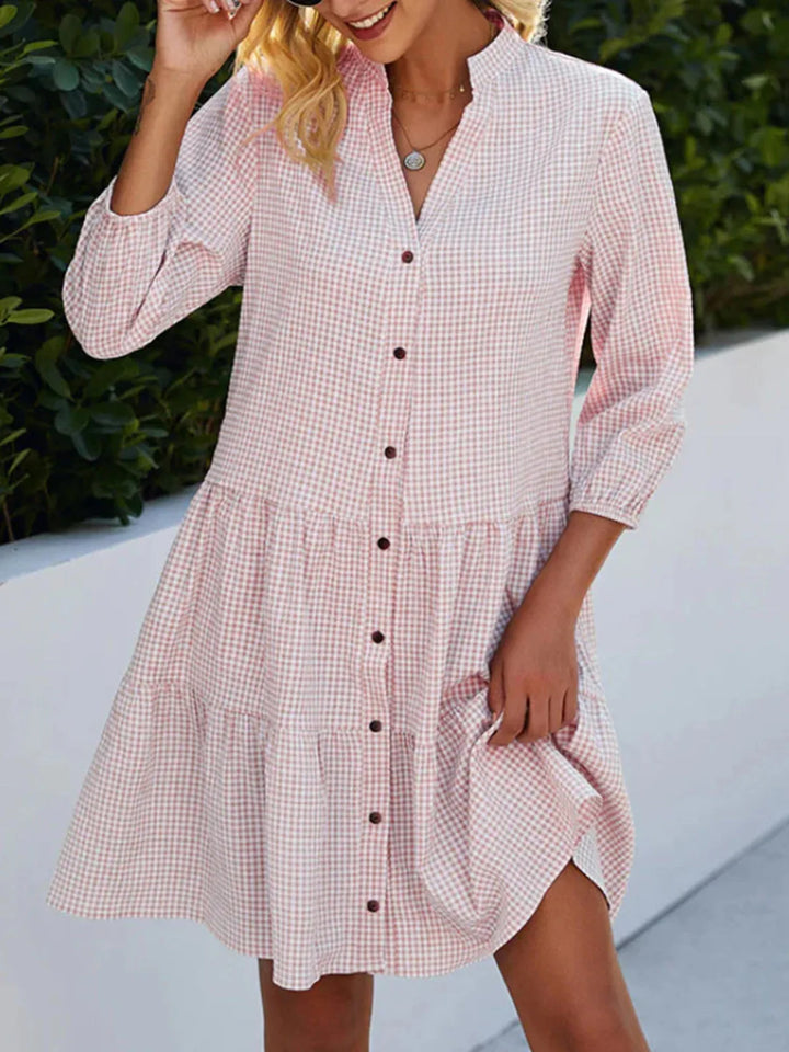 Comfortable women's flowy midi dress in classic gingham print, great for warm weather and effortless style.