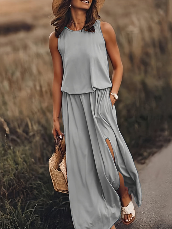 Women's long flowy maxi dress with an elastic waist, pockets, and a stylish side slit for movement.