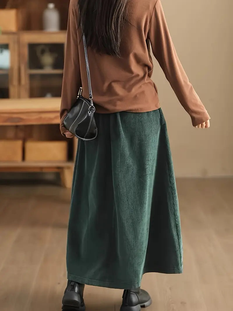 Elegant green A-line maxi skirt featuring a unique corset waist and flowy design for women.