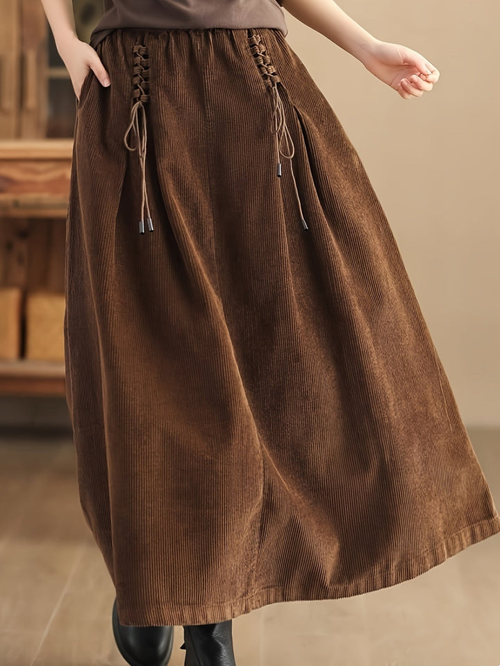 Chic black flowy maxi skirt for women, featuring a corset-style waist, ideal for casual or elegant wear.
