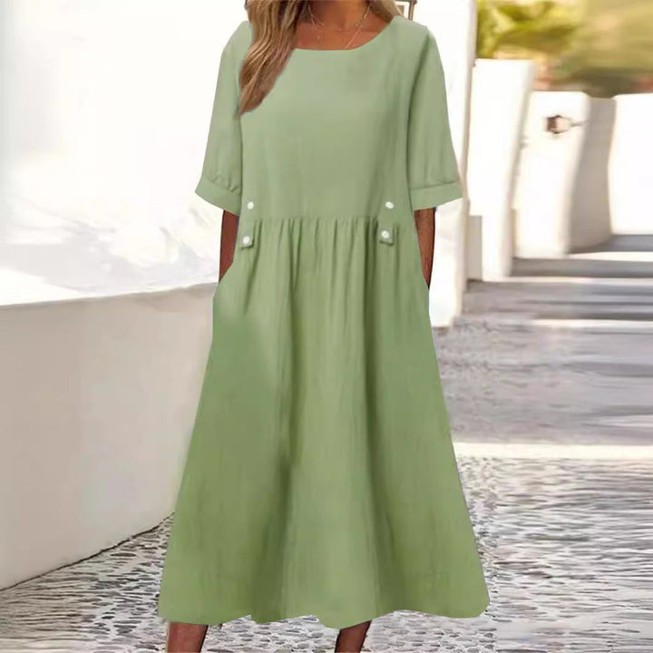 Elegant women's flowy midi dress. Comfortable and versatile summer dress with a relaxed fit & round neck.