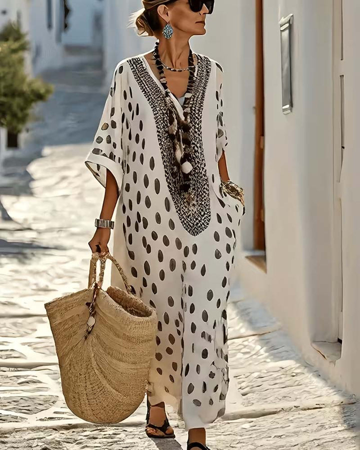 Women's polka dot flowy maxi kaftan dress featuring beautiful embroidery, perfect for beach or casual vacation.