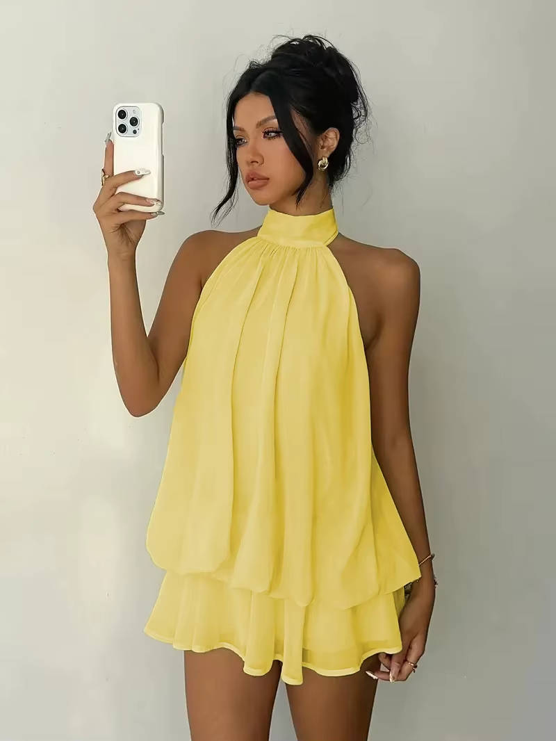 Women's flowy ruffle halter mini dress with open back, perfect for summer parties.