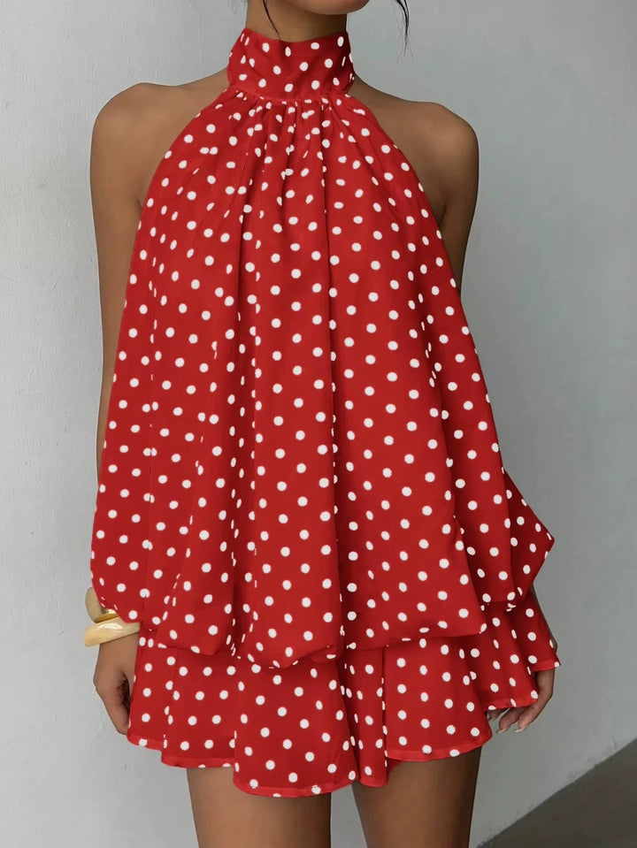 Dynamic shot of a women's flowy ruffle halter mini dress, highlighting its open back and airy movement.