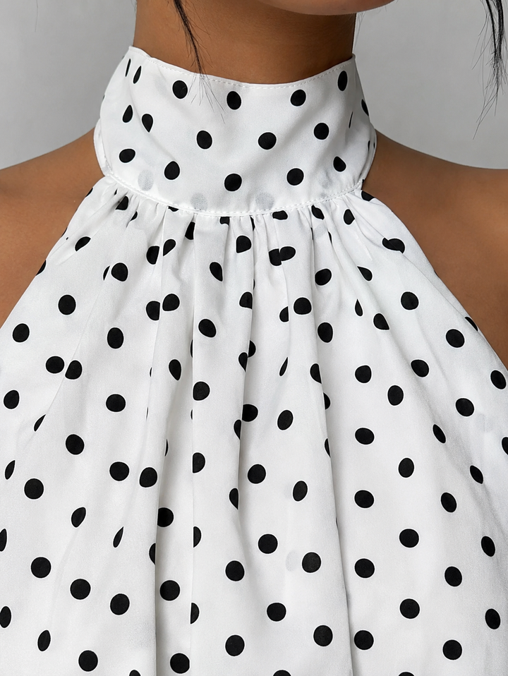 Chic women's halter neck mini dress with playful ruffles & open back, ideal for cocktail events.