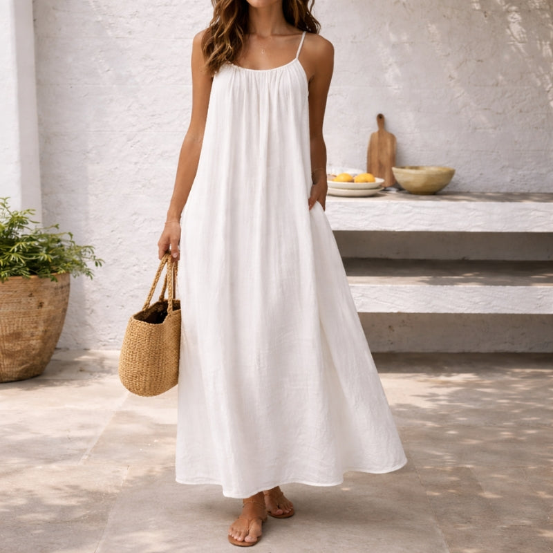 Elegant women's flowy maxi sundress with spaghetti straps, perfect for vacation & beachwear.