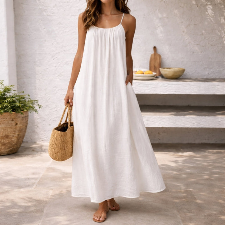 Elegant women's flowy maxi sundress with spaghetti straps, perfect for vacation & beachwear.