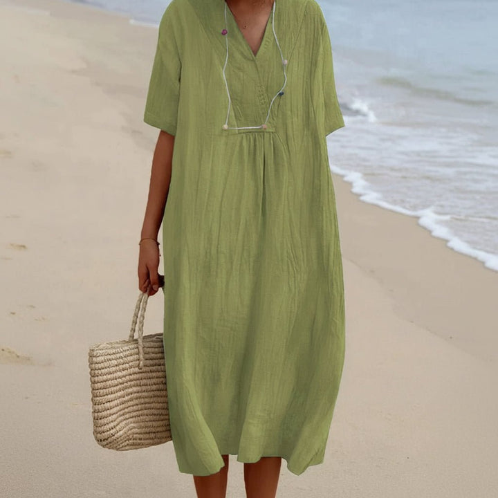 Women's comfortable flowy midi dress with practical pockets, ideal for summer casual wear & travel.