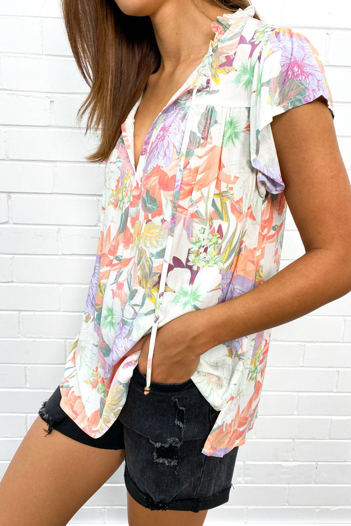 Women's flowy V-neck summer top with stylish fringe detail, perfect for warm weather casual wear.