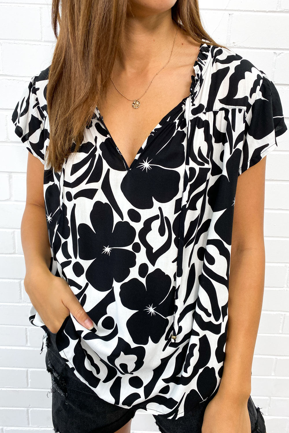 Breezy women's flowy V-neck summer top, perfect for casual outings with its chic fringe detail.