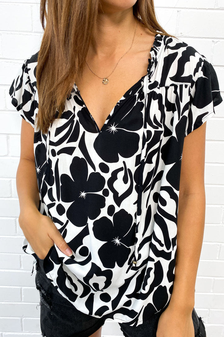 Breezy women's flowy V-neck summer top, perfect for casual outings with its chic fringe detail.